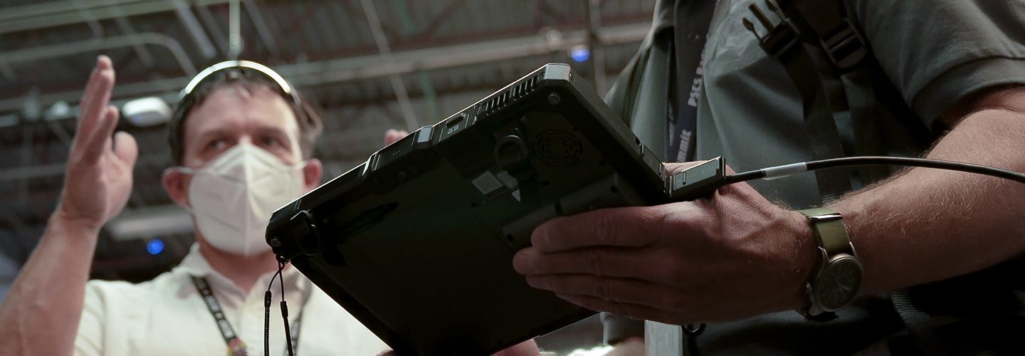 A researcher holds a tablet in one of the FirstNet Authority Technical Office facilities