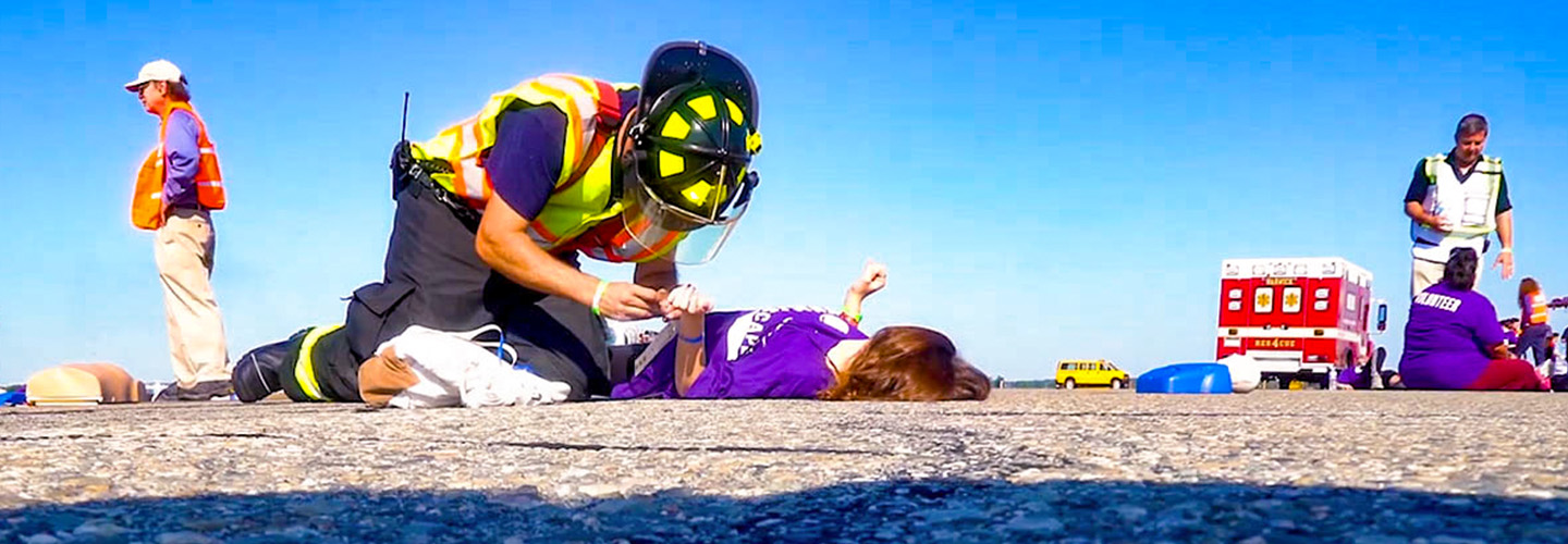 First responder providing medical care to a person on the ground During a routine emergency management exercise in Warwick, Rhode Island, first responders tested FirstNet's capabilities.