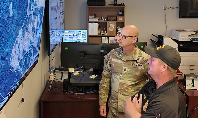 Public safety staff at Redstone Arsenal view a map on a screen showing asset locations