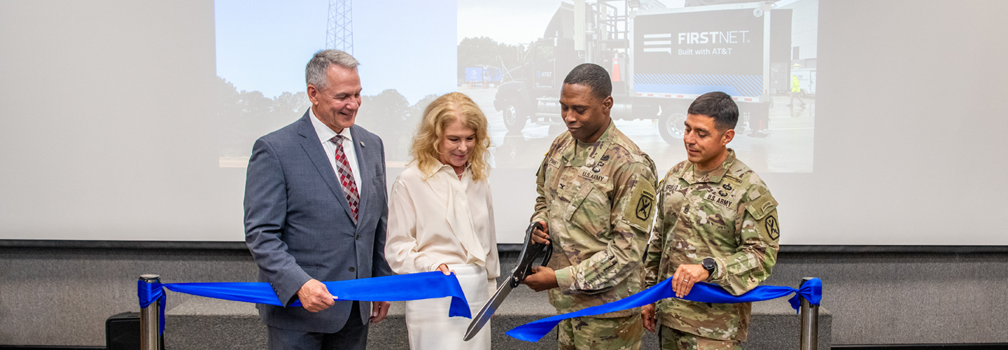 Fort Benning Garrison Commander Colonel Jerel Evans, along with representatives from the U.S. Army, FirstNet Authority, and AT&T, cuts a blue ribbon.