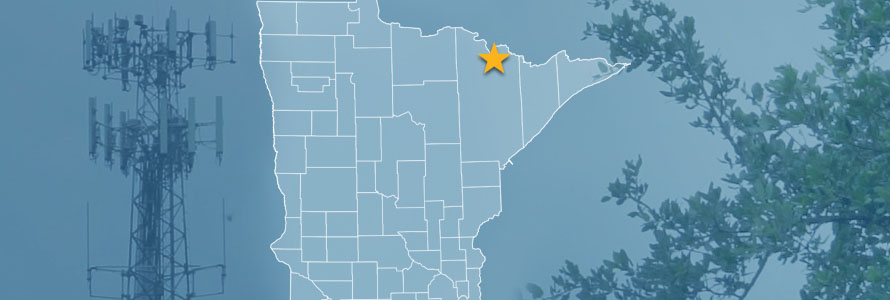 The state of Minnesota, with outlined county borders and a star locating the Kabetogama State Forest; a cell tower and tree