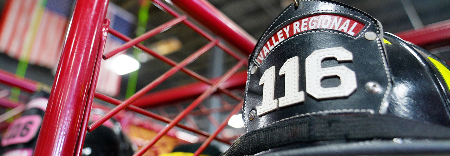 Valley Regional and Fire helmet on display in front of American flags