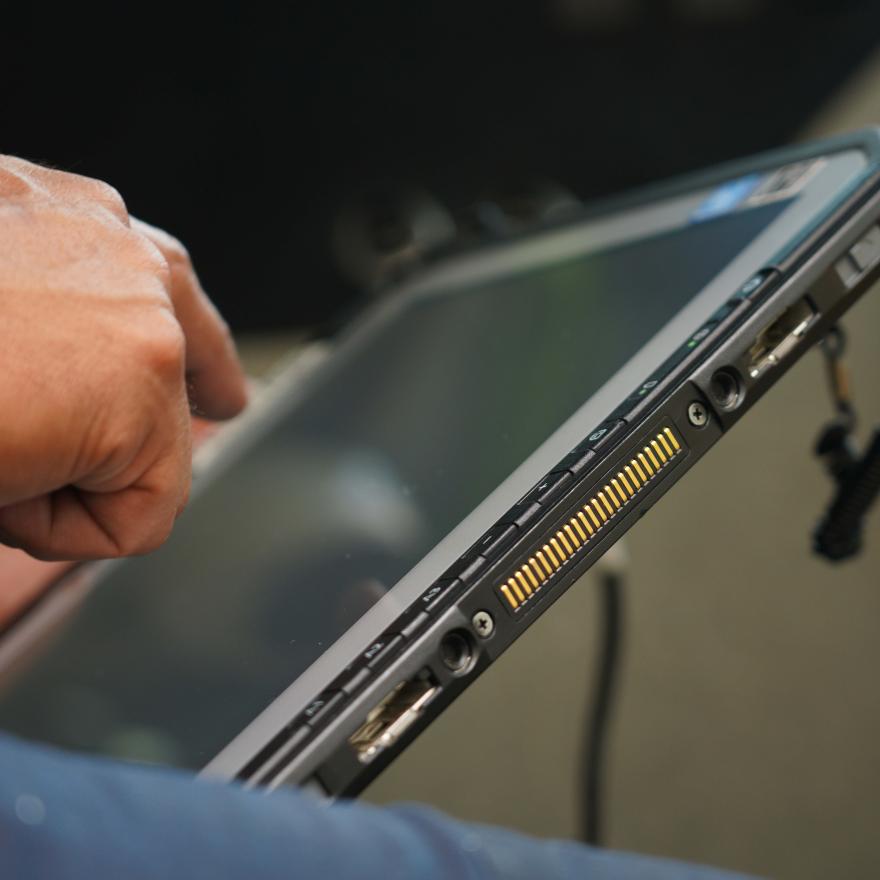 A firefighter uses a FirstNet tablet inside of a fire truck