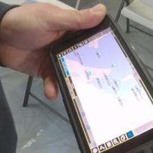 First responder hlding a cell phone viewing a map