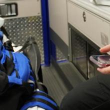 First responder in an ambulance holding a cell phone First responder in an ambulance holding a cell phone