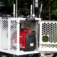 A man wearing a FirstNet shirt looks at a compact rapid deployable that is set up ready for use. A man wearing a FirstNet shirt looks at a compact rapid deployable that is set up ready for use.
