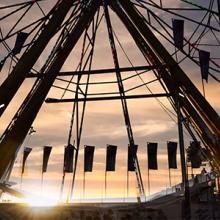 A Ferris wheel backlit by the sunset. A Ferris wheel backlit by the sunset.