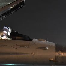 Air Force pilot sits in a jet at night. Air Force pilot sits in a jet at night.