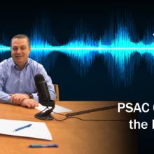 PSAC Chair Todd Early and Dave Buchanan talk into a microphone in front of a graphic representation of a soundwave.