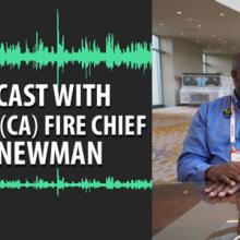 Chief Erik Newman and Dave Buchanan stand at a table together