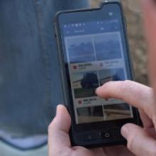 A police officer choosing an image to send on his FirstNet enabled smartphone