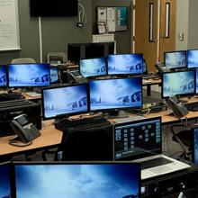 APCO_repost: A man sits surrounded by rows of monitors set up to serve as a mobile command center for Fulton County.