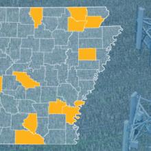 The state of Arkansas, with outlined county borders; a cell tower.