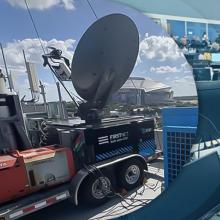 A FirstNet portable cell site on the left; on the right, public safety officials manage operations during the FIFA World Cup in the Dallas joint operations center. 