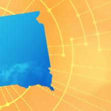 The silhouette of the State of South Dakota revealing a cell tower inside; radiating connectivity illustration