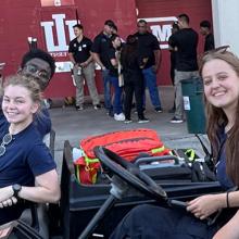 Planning for the crowd: How IC-EMS used FirstNet to elevate game day care at Indiana University Four Intra-Collegiate Emergency Medical Service (IC-EMS) students smiling at the camera from electric carts while on duty at the Indiana University football stadium.