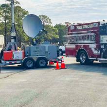 A FirstNet Compact Rapid Deployable and FirstNet, Fire & Rescue, and Police vehicles parked at Military Ocean Terminal Sunny Point, North Carolina