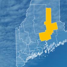 The state of Maine, with outlined county borders; a cell tower.
