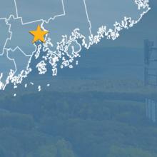 State of Maine with counties outlined; a star locating Bucksport, Naples, and Ogunquit; a cell tower
