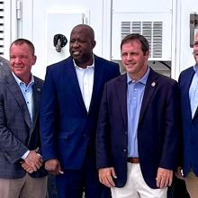 South Carolina public safety leaders, FirstNet Authority and AT&T staff, and U.S. Representative Russell Fry stand in front of a FirstNet SatCOLT