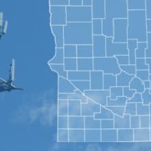 The state of Minnesota, with outlined county borders and a star locating the city of Kellogg; a cell tower