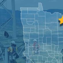 The State of Minnesota, with outlined county borders and a star; a cell tower