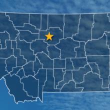 The state of Montana, with outlined county borders and a star locating cell site; a cell tower.