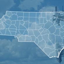 The state of North Carolina, with outlined county borders; a cell tower. The state of North Carolina, with outlined county borders; a cell tower