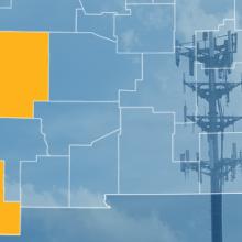 The state of New Mexico, with outlined county borders; a cell tower.