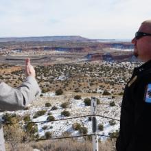 A public safety officer and a FirstNet Authority staff member speak with each other overlooking a Navajo reservation A public safety officer and a FirstNet Authority staff member speak with each other overlooking a Navajo reservation