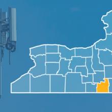 State of New York with counties outlined; Saratoga, Tioga, Clinton, Essex, Schoharie and Washington Counties highlighted, a cell tower