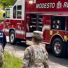 A group of Sacramento Fire Department firefighters standing in front of a fire engine