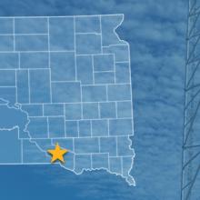 The state of South Dakota, with outlined county borders and a star locating Yankton Sioux Reservation, South Dakota; a cell tower.