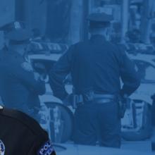 Sylvia Moir headshot, a group of four police officers checking cars at a routine traffic stop in a busy city street