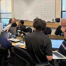 Staff, including representatives from the FirstNet Authority, support a San Francisco Bay area World Cup match at the Interoperable Communications Help Desk, U.S. fans celebrate with flags and smoke cannons during the World Cup.