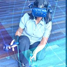 Four Tech to Protect participants code in collaboration at a table filled with laptops, a Haptics Challenge judge tests virtual reality simulations, a FirstNet Authority speaker at TEEX UnderFire gestures in front of an audience