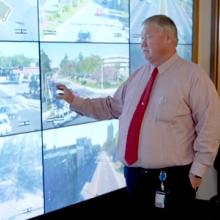 Public works staff from Gainesville, Florida consult several screens showing live stream video from around the city. 