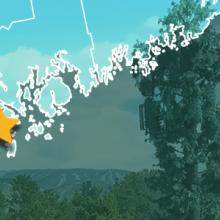 County map of Maine, star over Stonington, cell tower against mountains