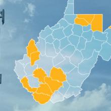 The state of West Virginia, with outlined county borders; a cell tower.