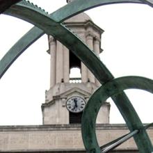 The Old Main Bell Tower sits behind the Old Main Armillary Sphere on the Pennsylvania State University campus.