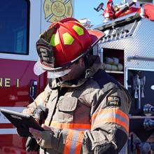 A Wayne County firefighter uses a tablet A Wayne County firefighter uses a tablet