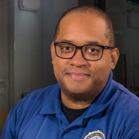 Kevin Mitchell in front of a Oxford Police Mobile Operations vehicle