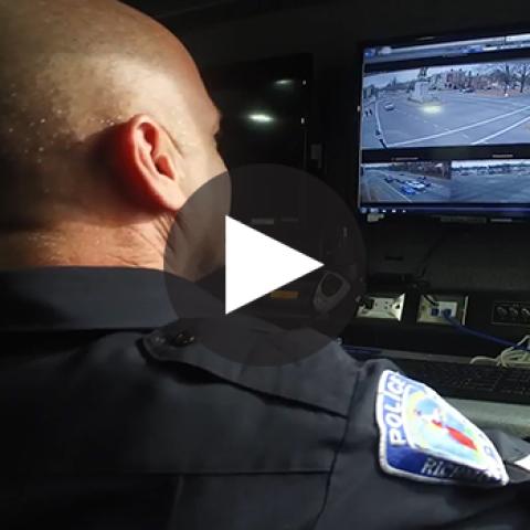 An officer with the city of Richmond reviews video footage 