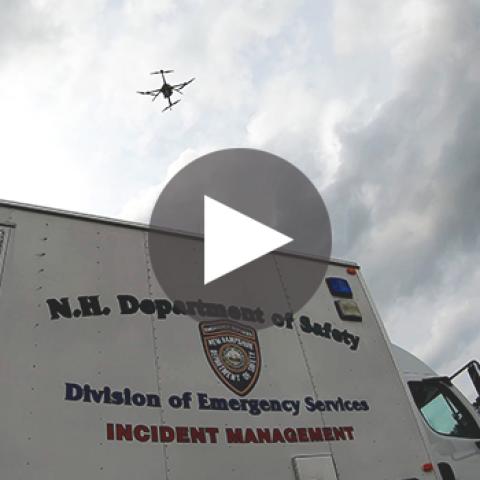 FirstNet drone flying over NH Department of Safety Management van 