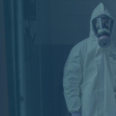 Two EMS workers wearing hazmat suits