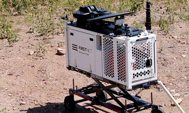 A FirstNet Compact Rapid Deployable set up in a field to provide coverage