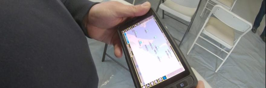 First responder hlding a cell phone viewing a map