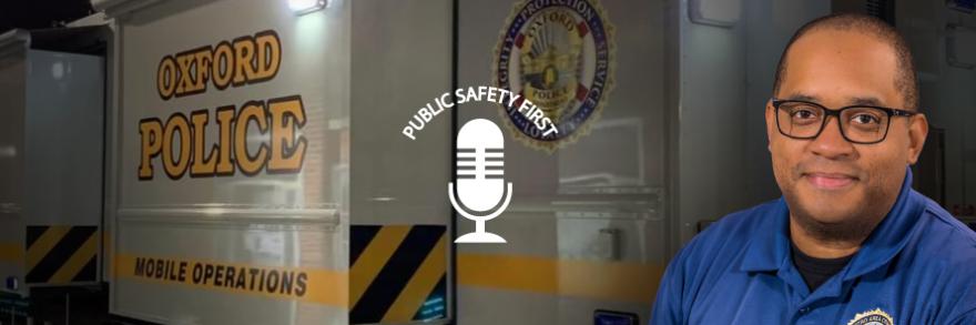 Kevin Mitchell in front of a Oxford Police Mobile Operations vehicle