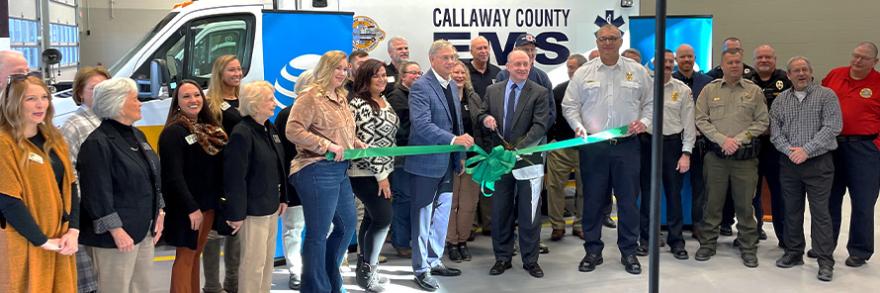 Local leaders cut a ribbon in front of a Callaway County EMS ambulance