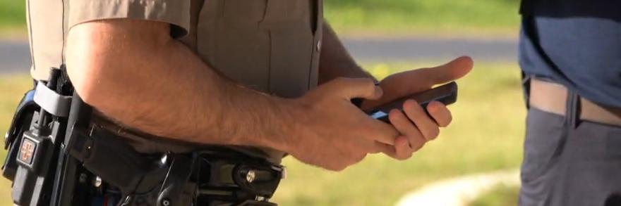 Law enforcement officer using smart device 